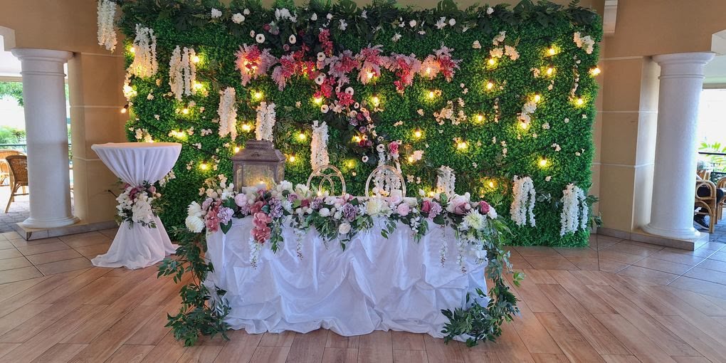 Floral wall backdrop with fairy lights and a bridal table in the Pavilion